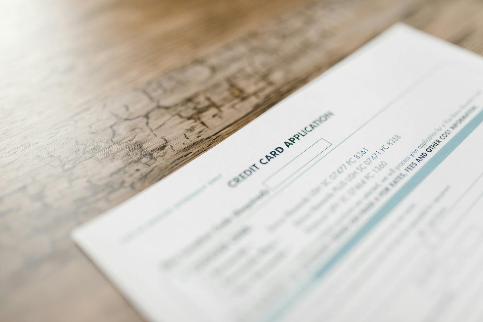 Home A Credit Card Application On A Wooden